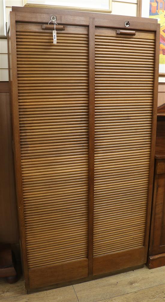 An oak double tambour shutter filing cabinet W.92cm